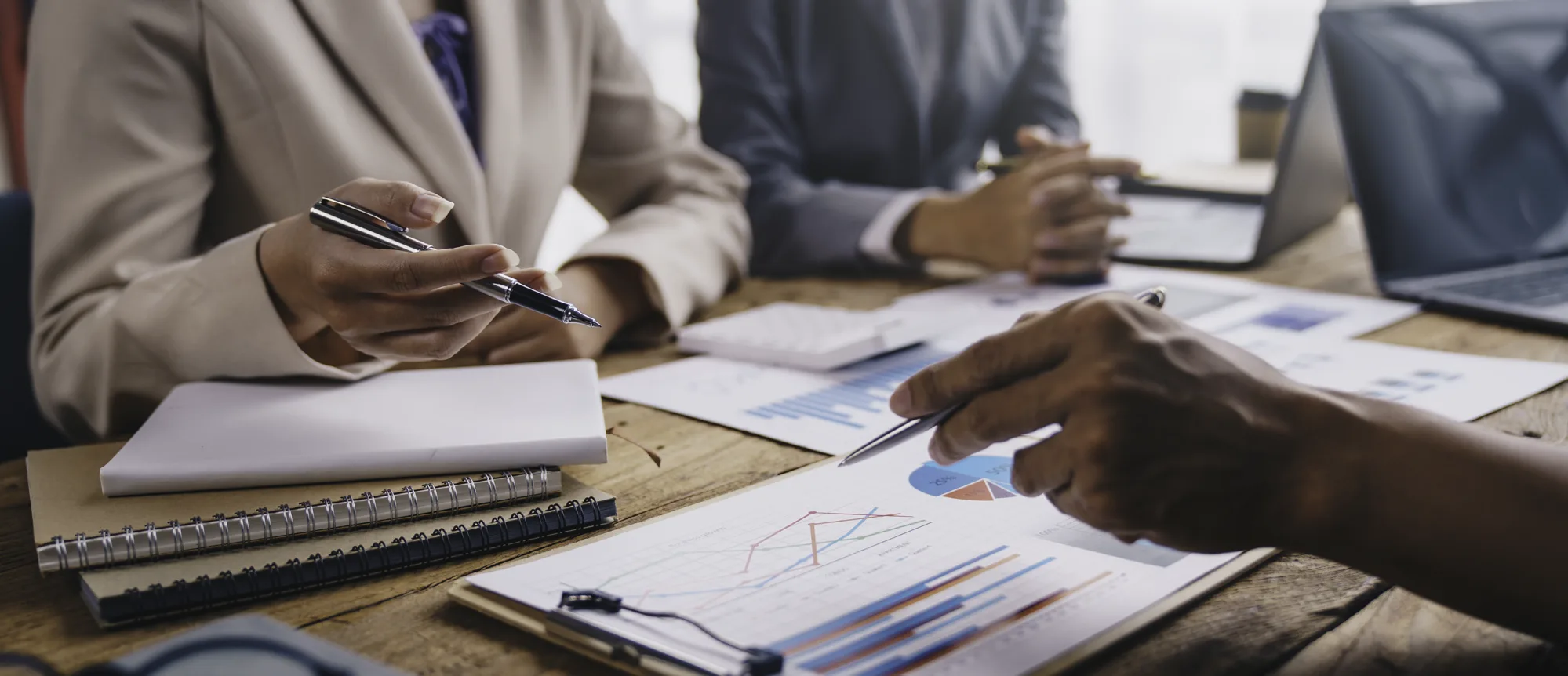 Consultants reviewing commercial performance data during a business meeting